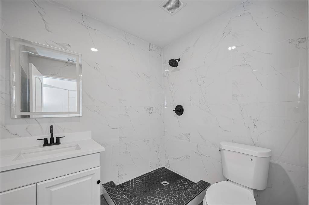 Fully remodeled bathrooms with elegant tile wall.