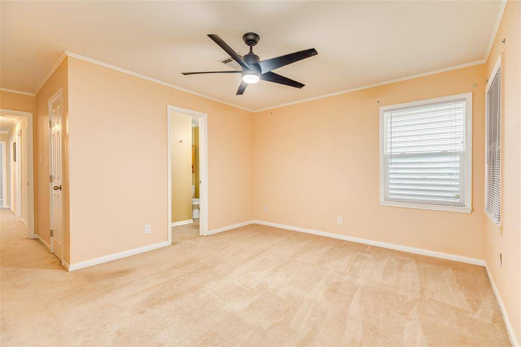 The Primary bedroom offers a set of corner windows overlooking the backyard and an en-suite bath with a walk-in shower.