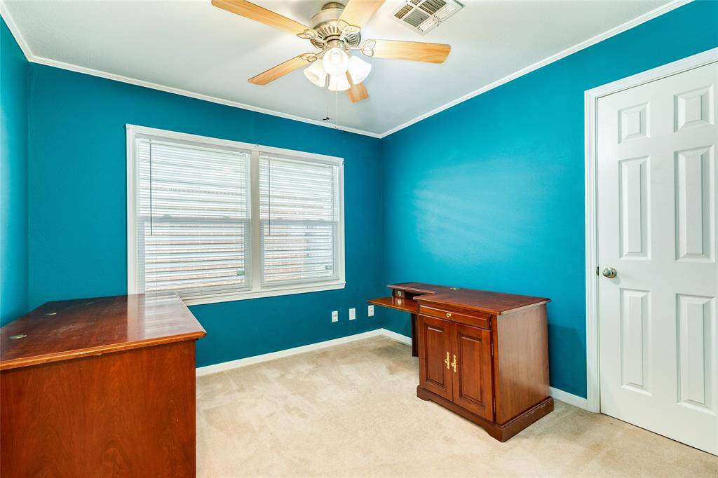 Bedroom two is quite spacious, features custom jewel tone colors, lots of natural light, and a walk-in closet.