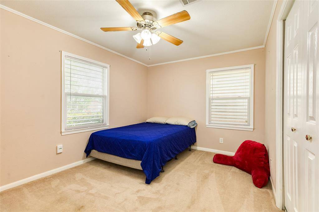 Bedroom three is at the front of the house and the large windows overlook the front yard.