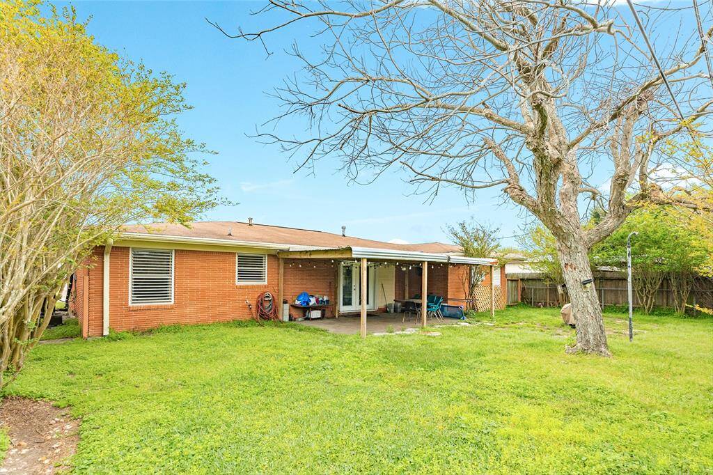 The backyard is spacious and features a large covered patio.