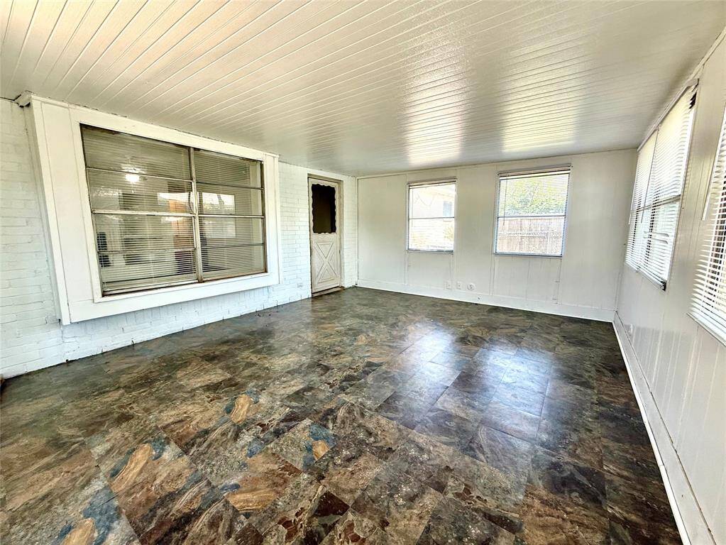 Charming enclosed patio seamlessly extends from the living room, perfect for relaxation and entertaining.
