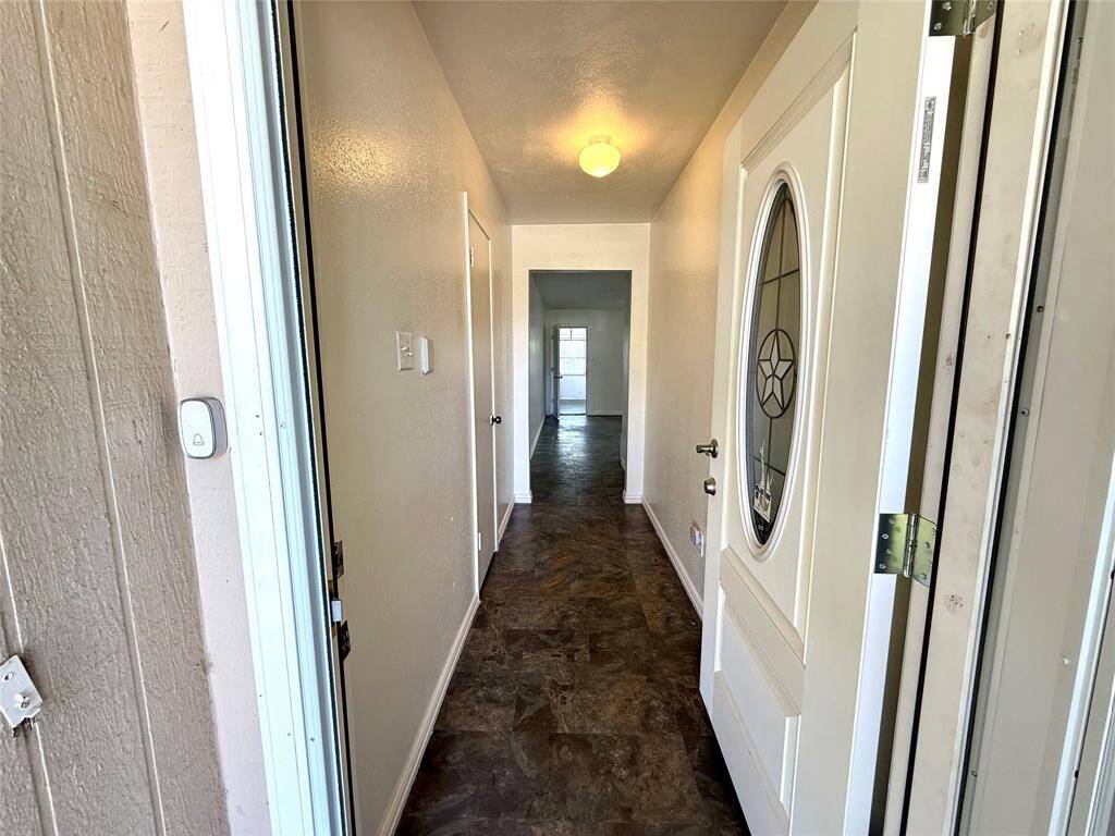 Step into the welcoming hallway, seamlessly guiding you to the bedrooms on the left.