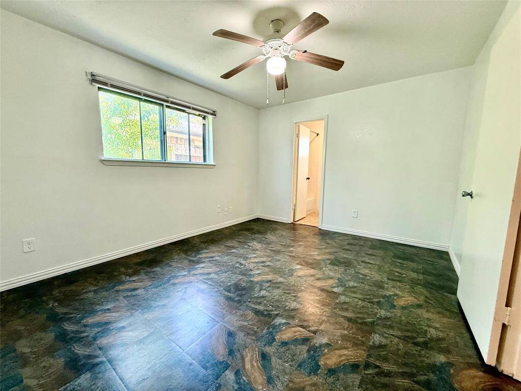 Spacious primary bedroom with side-house location for added privacy and natural light.