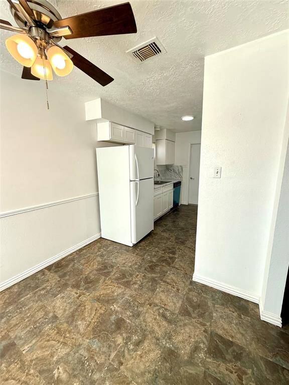 Charming galley kitchen with refrigerator included.