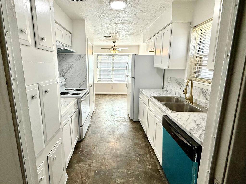 This kitchen boasts a brand new dishwasher and includes a refrigerator.