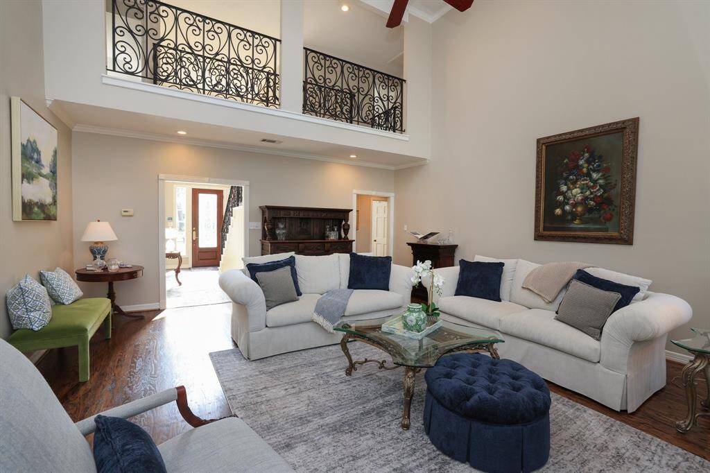 Two story living room is the focal point of the home with two stories of windows with plantation shutters.