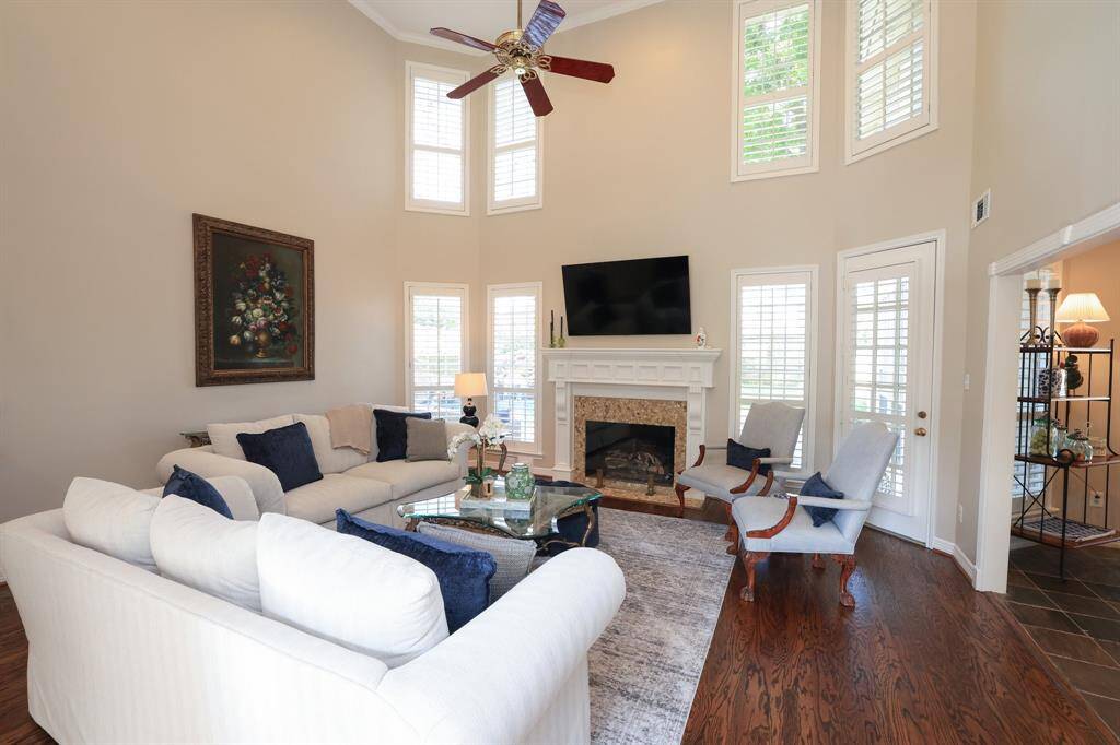 The second floor cat walk with wrought iron railing over looks the living room.