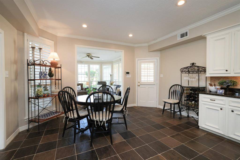 The breakfast area is located adjacent to the living area and is open to the sun room.