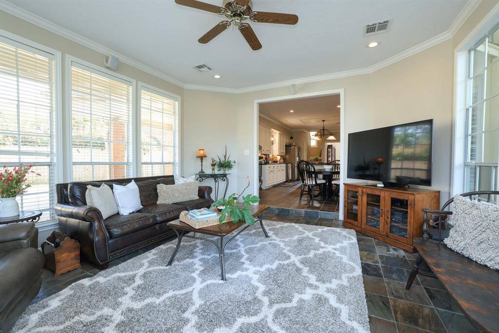This is truly a beautiful sun room surrounded by windows and natural light with panoramic views of the back yard.