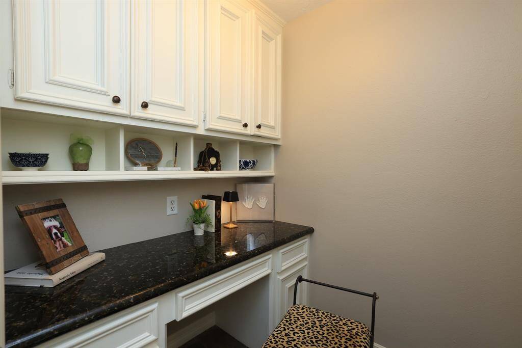 The formal dining room can be seen in the distance. The door to the right is a convenient office space.