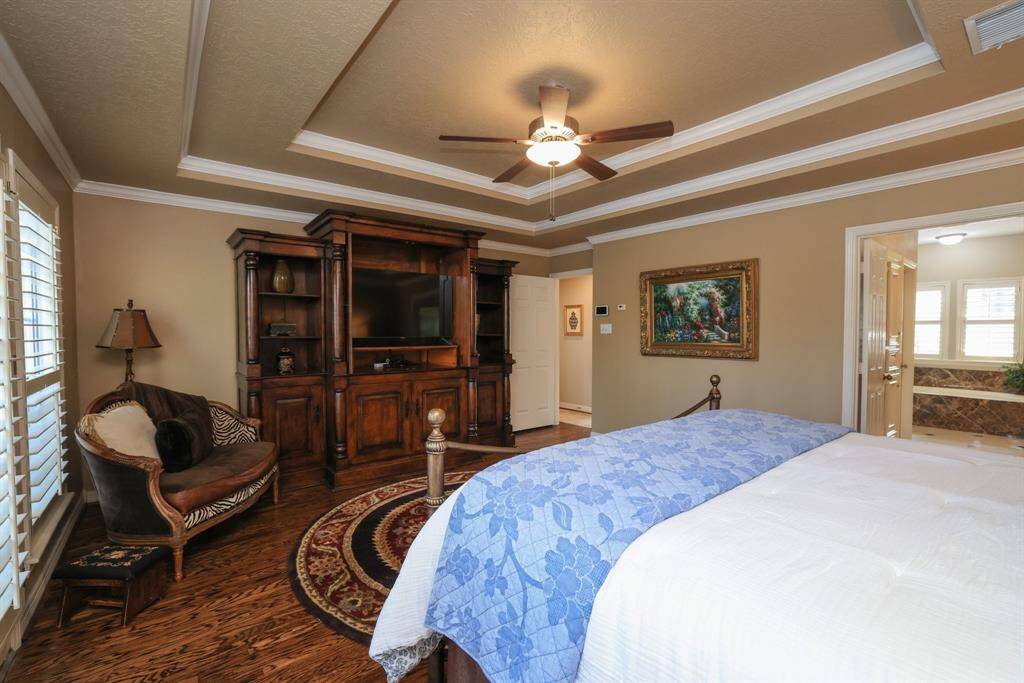 The primary bedroom is amazing with beautiful refinished hard wood floors and plantation shutters with views of the back yard.