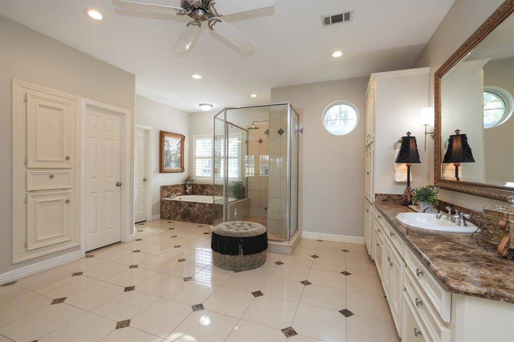 Primary bedroom has stepped ceiling and a wonderful bathroom shown to the right.