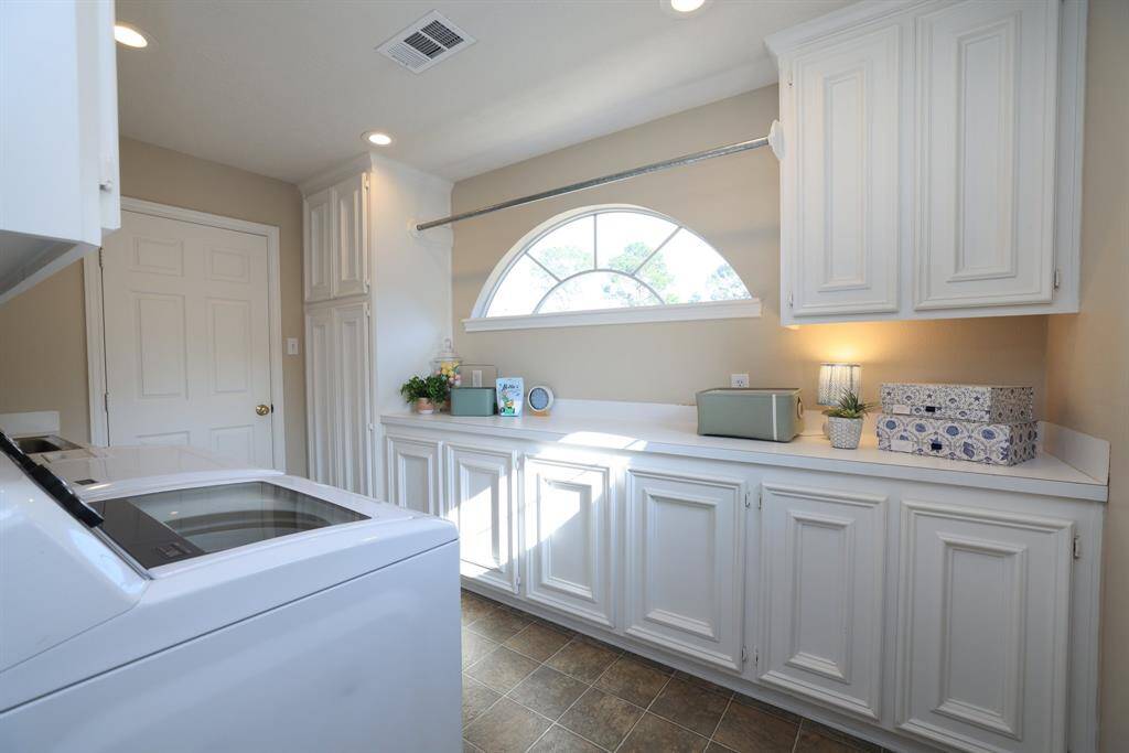 This second floor game room has a wall of built ins and a second stairway down to the kitchen.