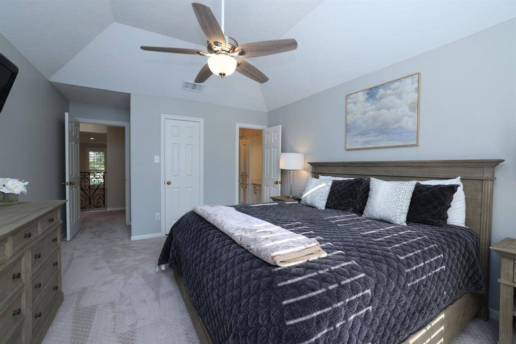 This bedroom is located at the front of the house and has plantation shutters.