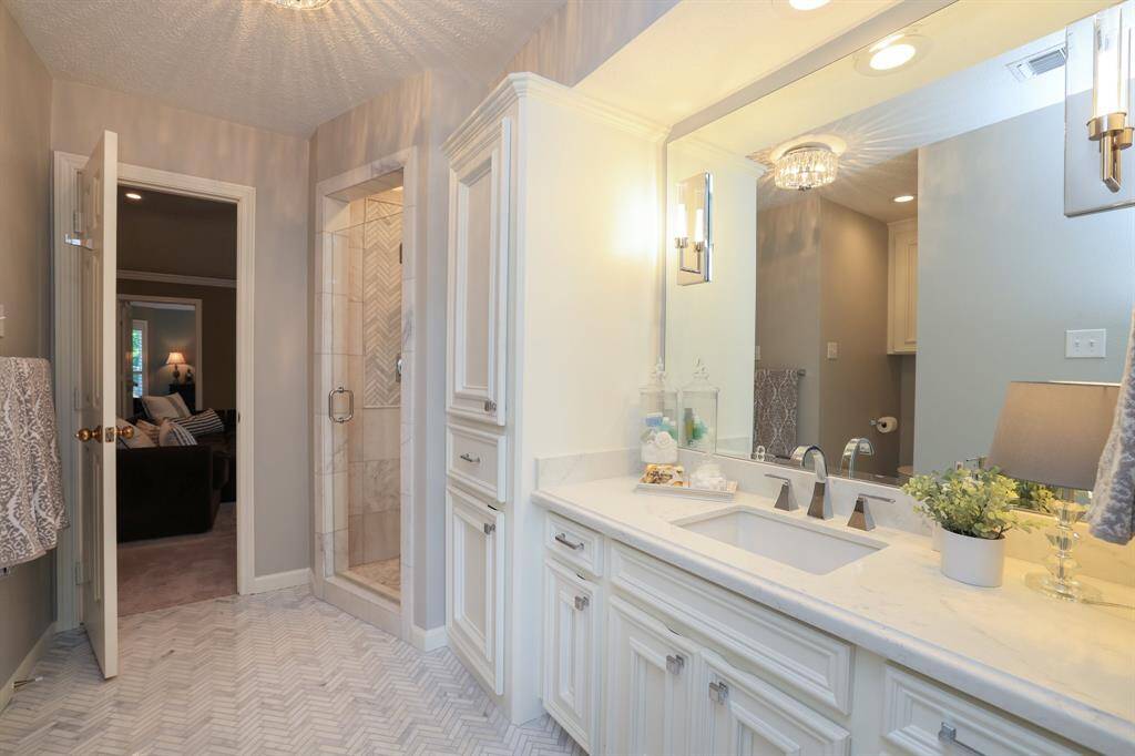 This bedroom has access to a beautifully remodeled bathroom.
