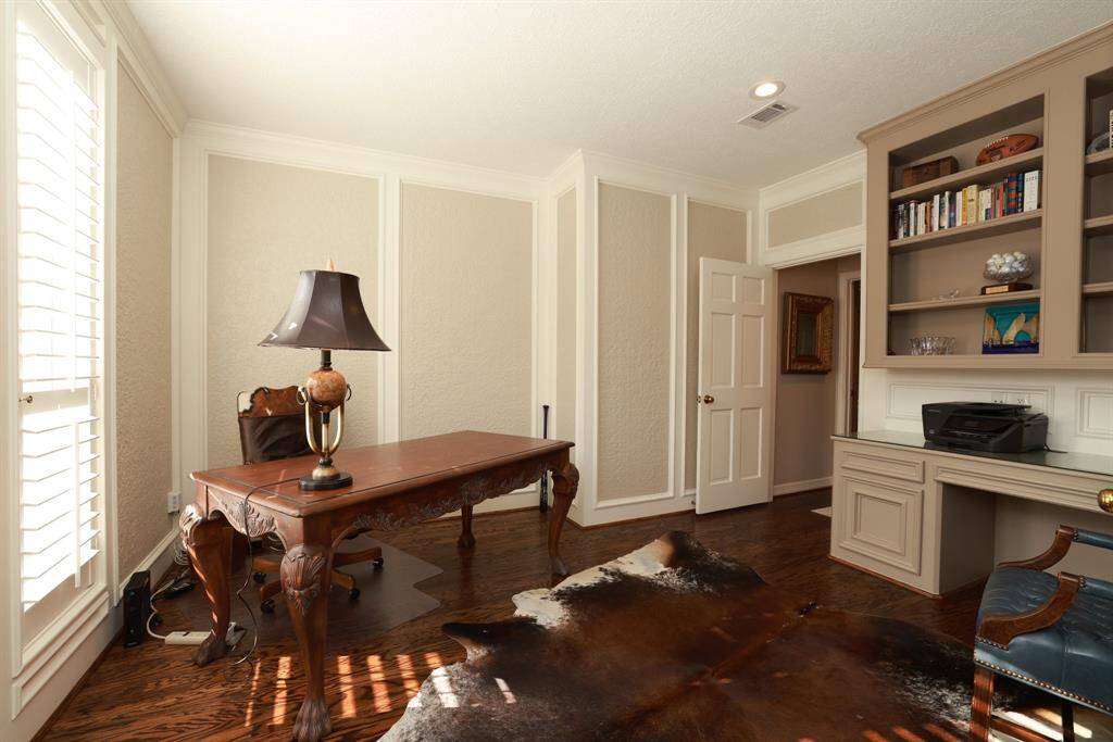 Elegant powder bathroom off the entry with unique pedestal sink.