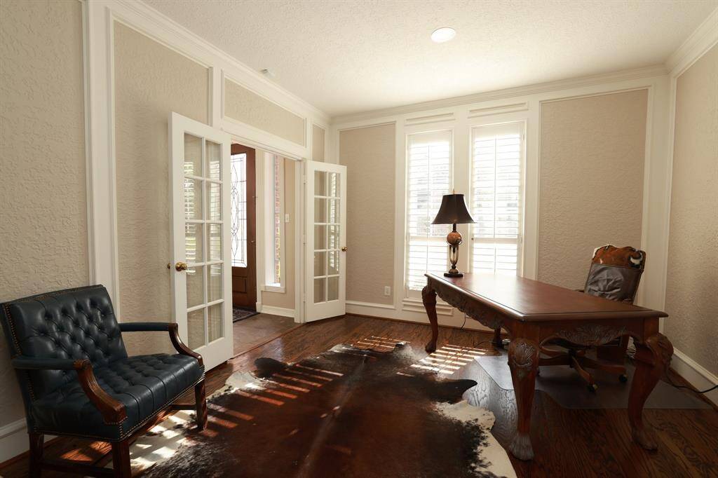 Formal dining room with newly refinished wood floors and plantation shutters.