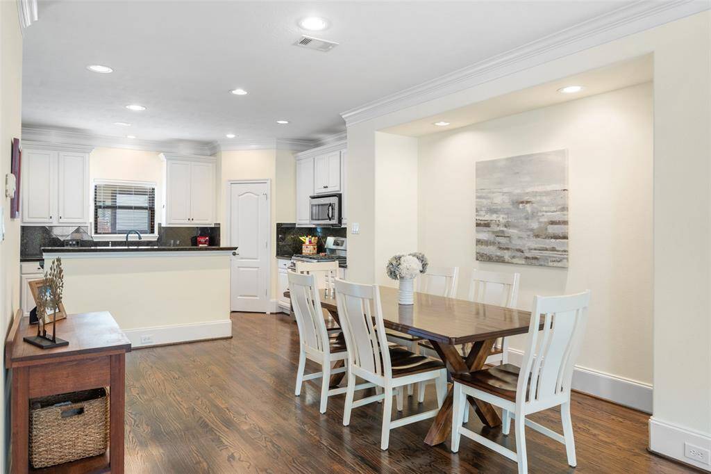 This dining room is spacious enough to accommodate a large dining table. It also features an inset area perfect for showcasing a favorite painting or family pictures, and is conveniently adjacent to the kitchen, creating a seamless flow for entertaining