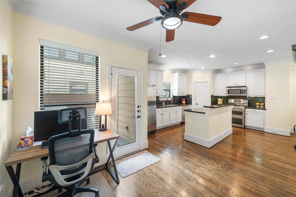 The breakfast room offers a view toward the kitchen, providing a cozy spot that seamlessly connects to the heart of the home