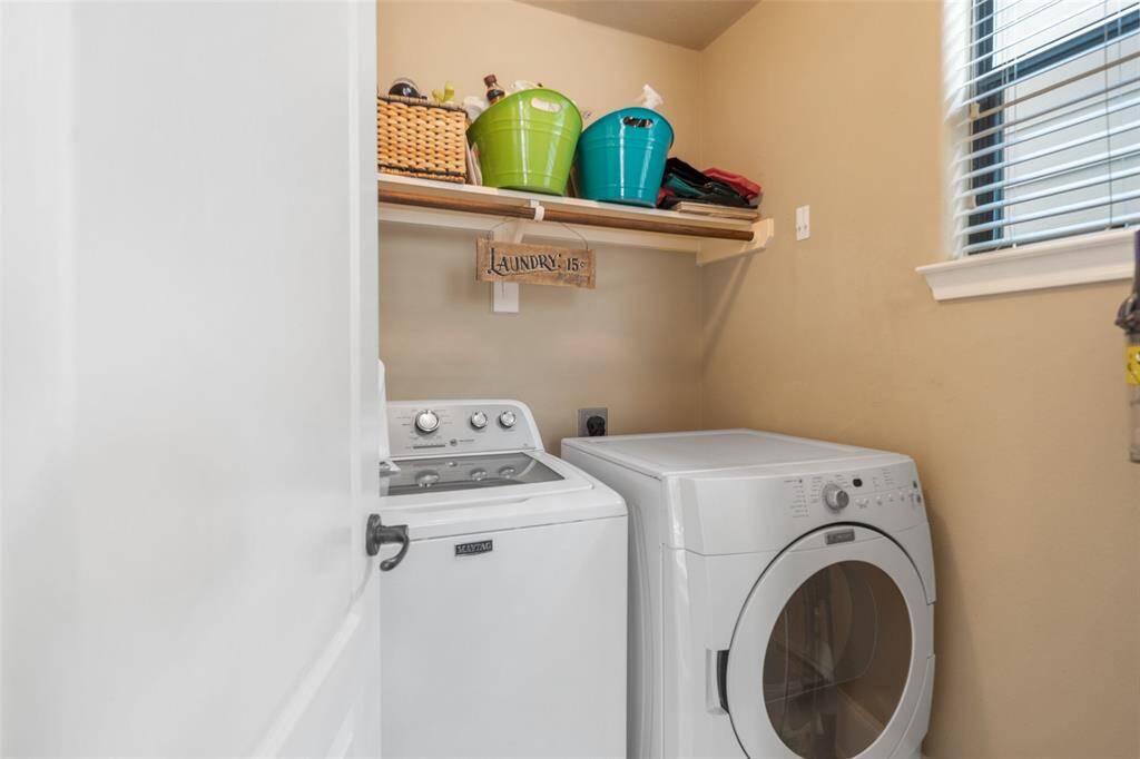 The laundry room, tucked away from the kitchen on the second floor, is large enough to accommodate full-sized washer and dryer, offering both convenience and ample storage space.