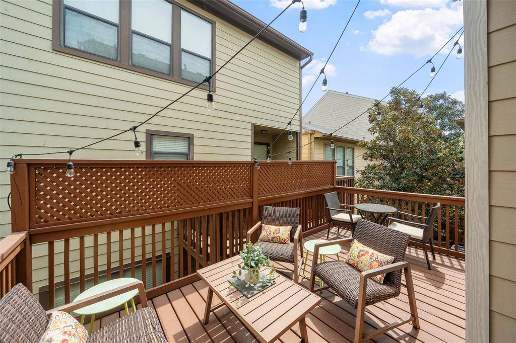 Step out onto the large second-floor deck, perfect for dining al fresco or enjoying Houston weather. With ample space for outdoor living furniture and a bistro table for two, it's an ideal spot for entertaining friends and family.