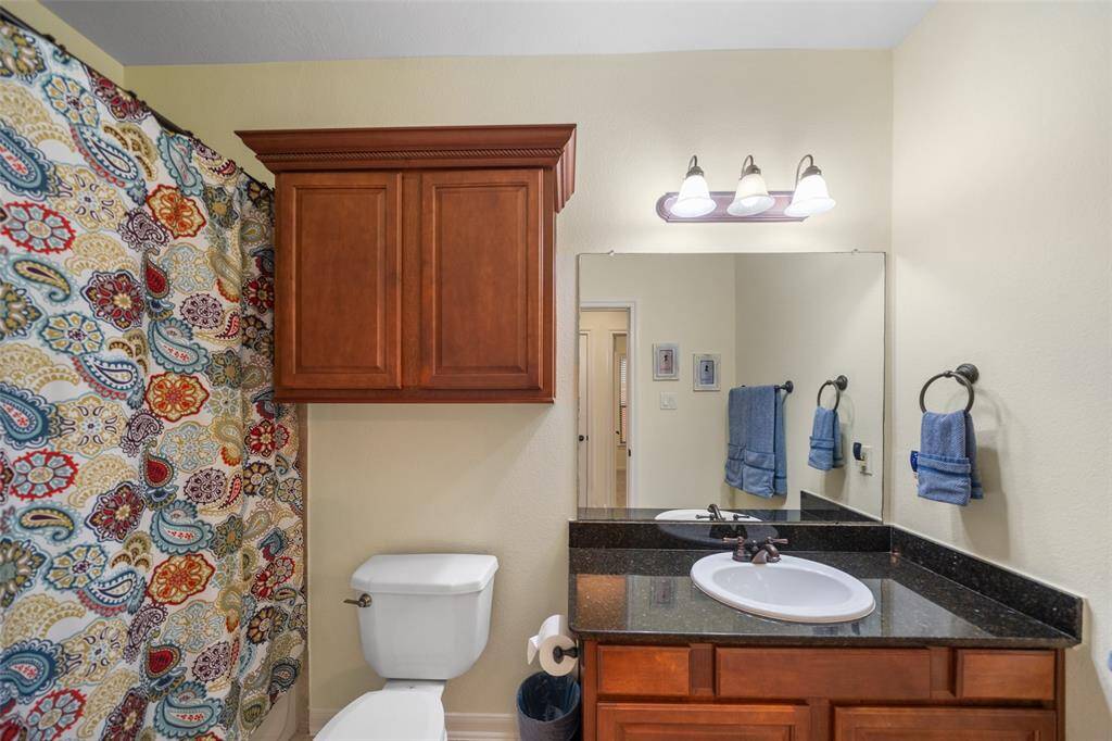 Conveniently located with the two first-floor bedrooms, this secondary bathroom features a granite single vanity and a tub/shower combo, offering easy access for your family or guests.