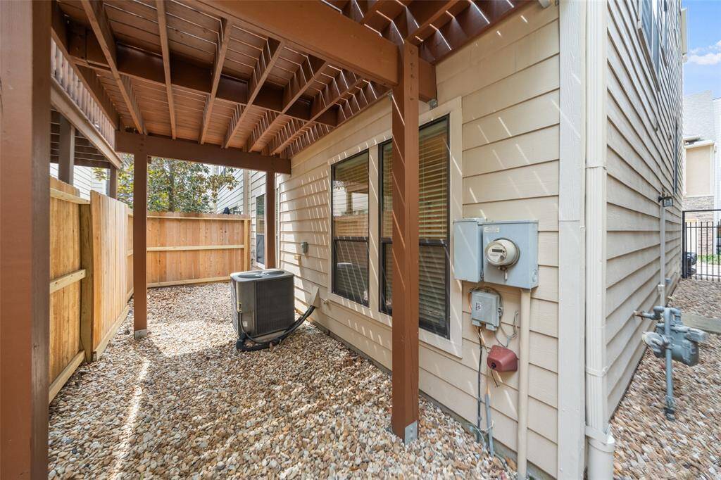 The low-maintenance gravel backyard is perfect for easy upkeep and offers shade from the upper deck added by the owners