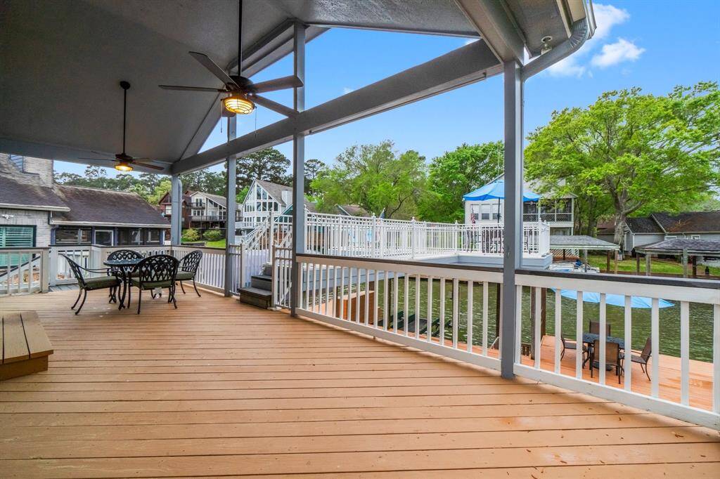 Large back covered deck with new ceiling fans.