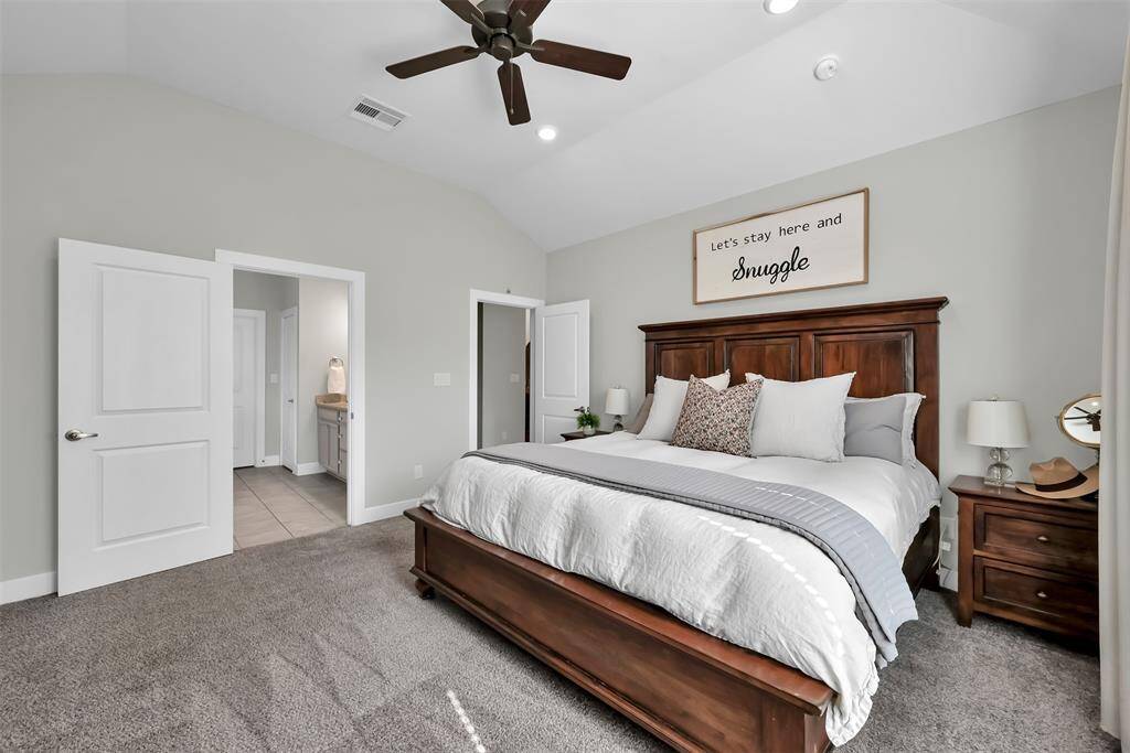 Enjoy the convenience of a primary bedroom adjacent to the laundry room, featuring large windows with peaceful backyard views.