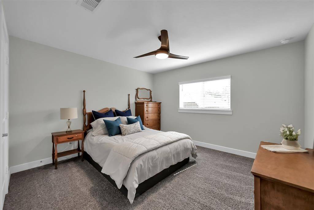 Secondary bedroom 2 offers convenient access to a shared bath and walk-in closet.