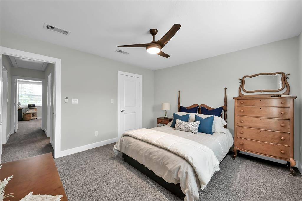 Secondary bedroom 2 offers convenient access to a shared bath and walk-in closet.