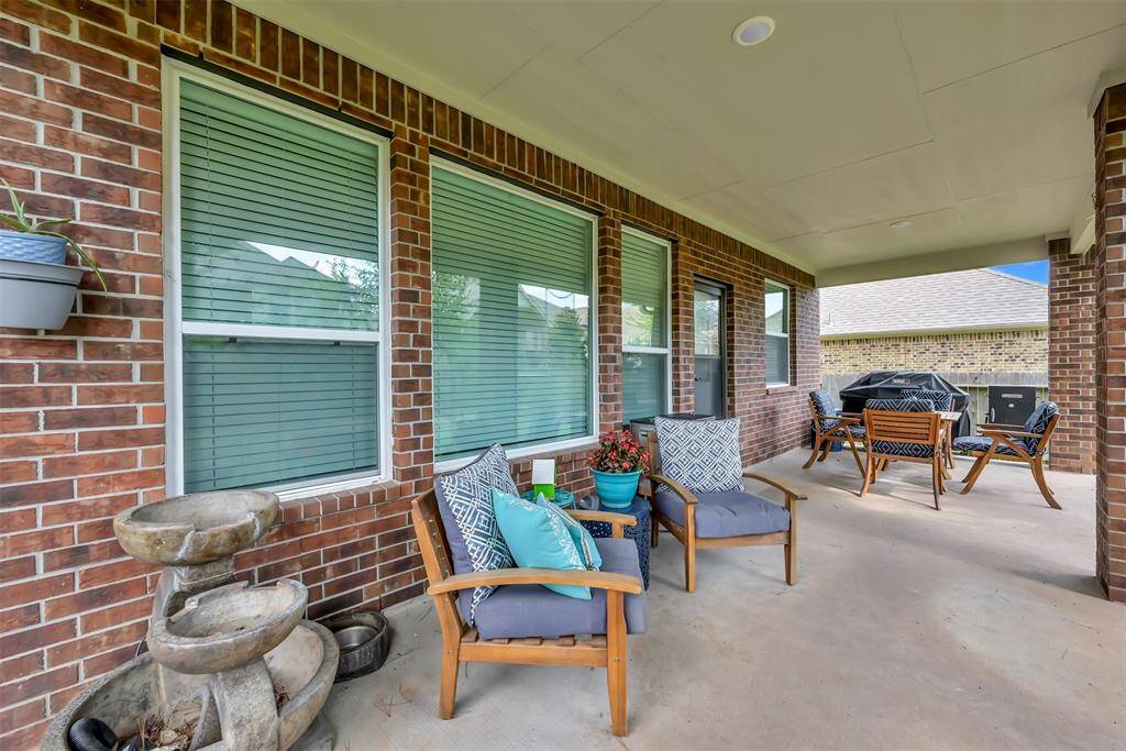 The covered patio is an ideal spot to enjoy the spacious backyard.