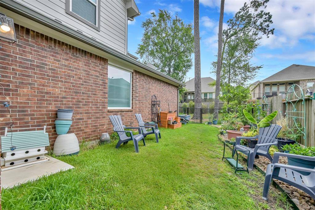 The spacious, fenced off side yard is perfect for a dog run or garden
