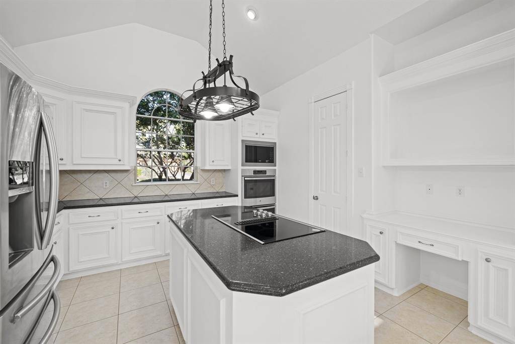 Additional view highlights the custom built in shelves and cabinets.