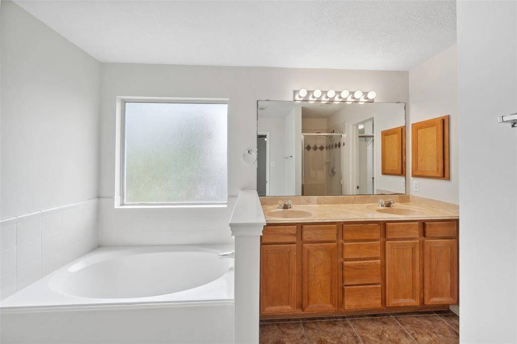 The primary bath has double sinks and a garden tub.