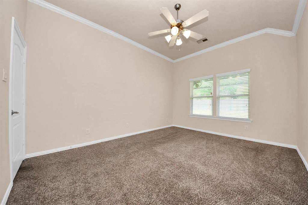 Primary bedroom with a backyard view