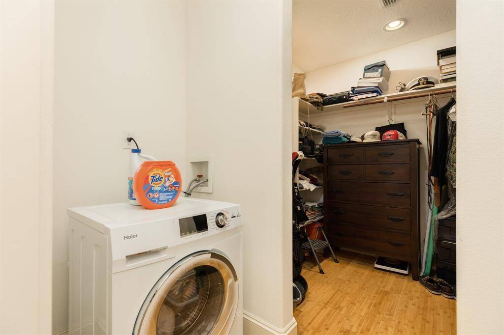 Large walk in closet with all in one washer/dryer combo unit