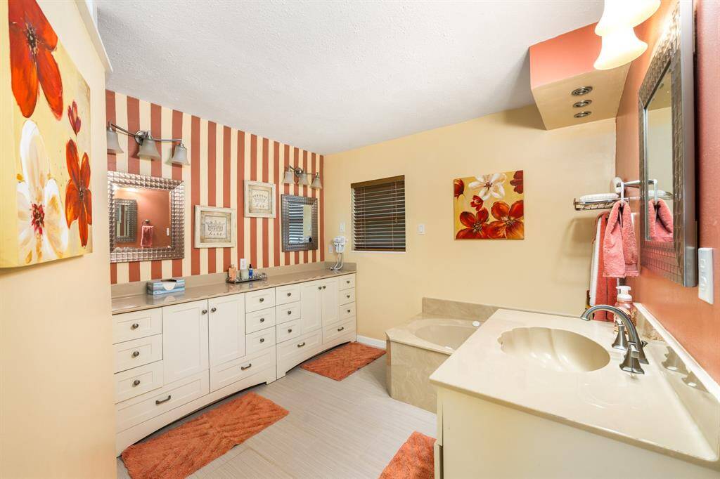 Primary ensuite with double vanities and a soaking tub, shower is separate.