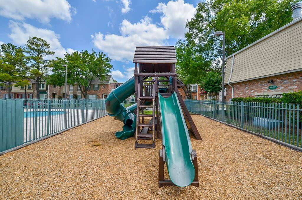 Discover endless fun for kids with this charming play set, featuring slides and climbing structures, perfect for creating lasting memories in a safe, fenced area.