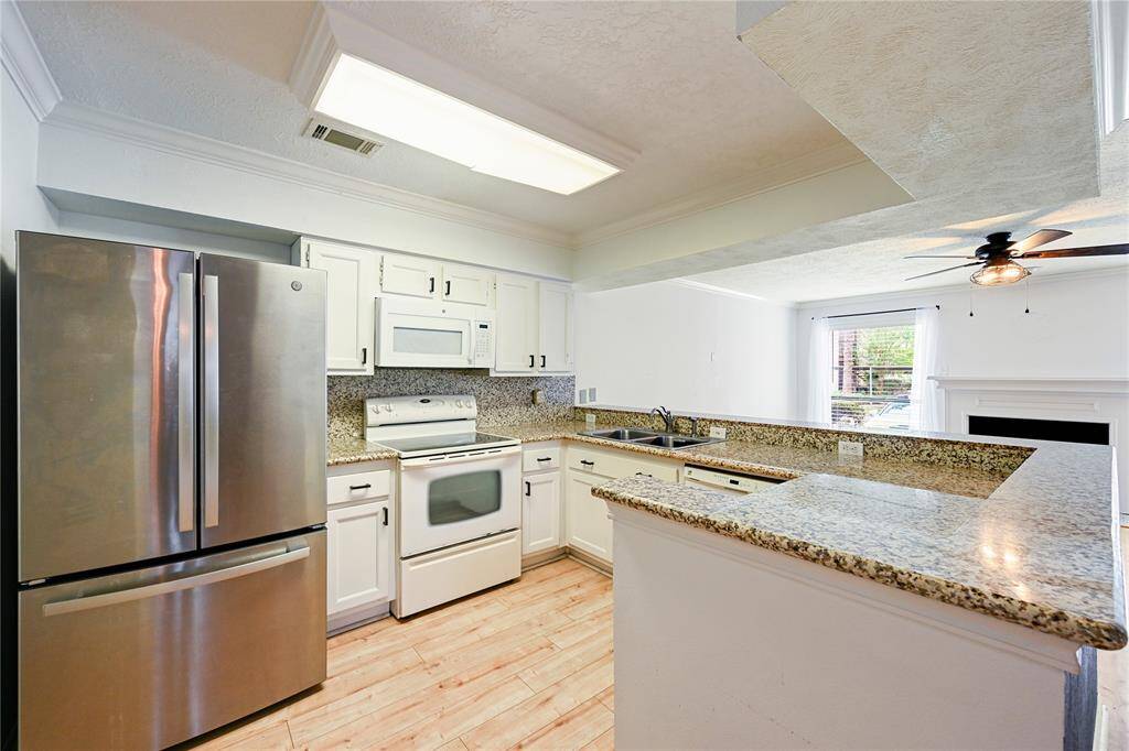 The appliances in this photo are included; Refrigerator, microwave, oven, and dishwasher