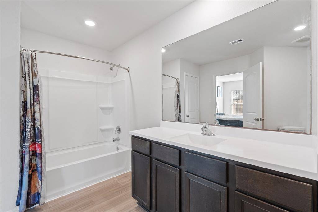 The en-suite bathroom offers a spa-like atmosphere with its elegant design, high end finishes, and tasteful lighting, creating a retreat within your own home.