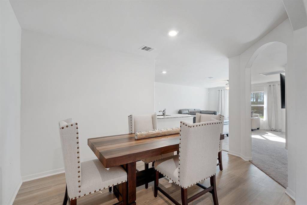 The dining area is a perfect blend of style and functionality, providing an inviting space for memorable meals and gatherings.