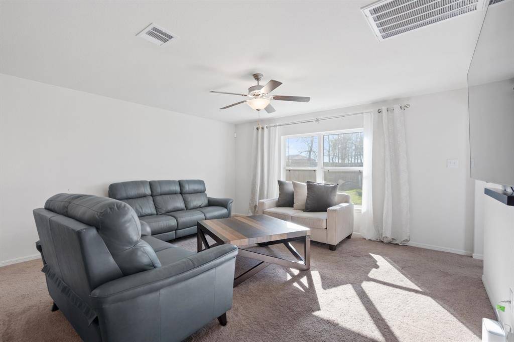 Your family room has ample space to entertain family and friends. This space features beautiful floors, fresh paint, ceiling fan with lighting, and high ceilings.