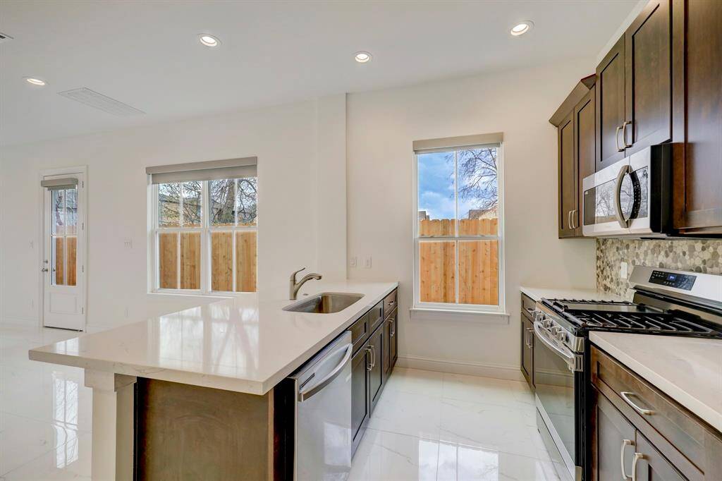 A closer look at the kitchen’s modern finishes, quartz countertops, and included appliances—style and function combined
