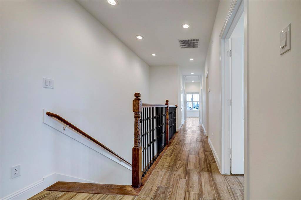 Step into the upstairs hallway with a glimpse of the spacious rooms waiting to be made your own.