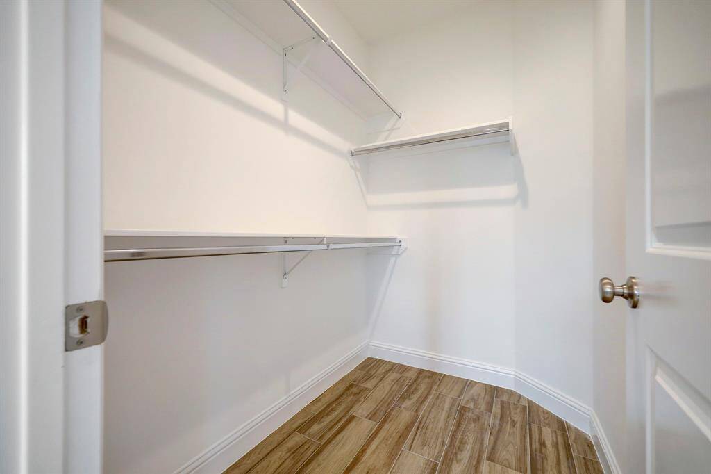 One of two spacious walk-in closets in the primary bedroom, designed for maximum organization