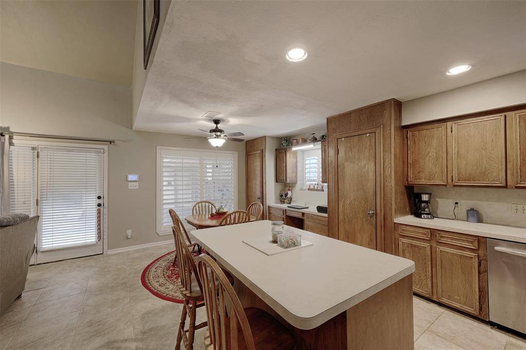 Bright open kitchen with two built in pantries and desk that could also be a serving area.  Custom shutters adorn the windows throughout the home.