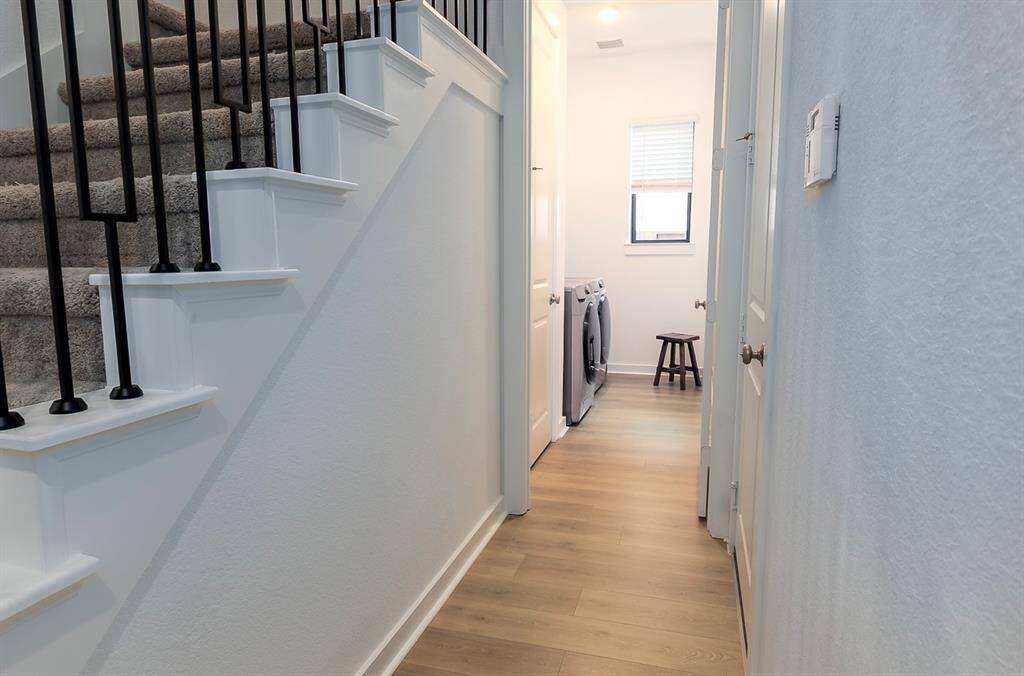 Conveniently located laundry room featuring modern appliances and ample natural light.