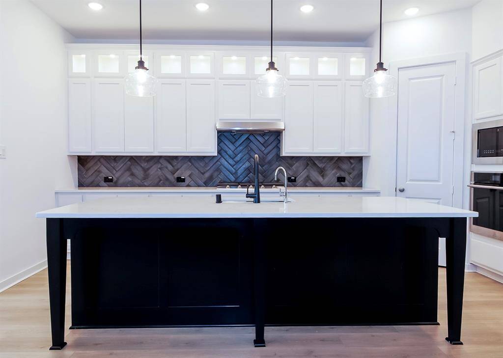Spacious kitchen featuring a stunning island, perfect for cooking and entertaining.